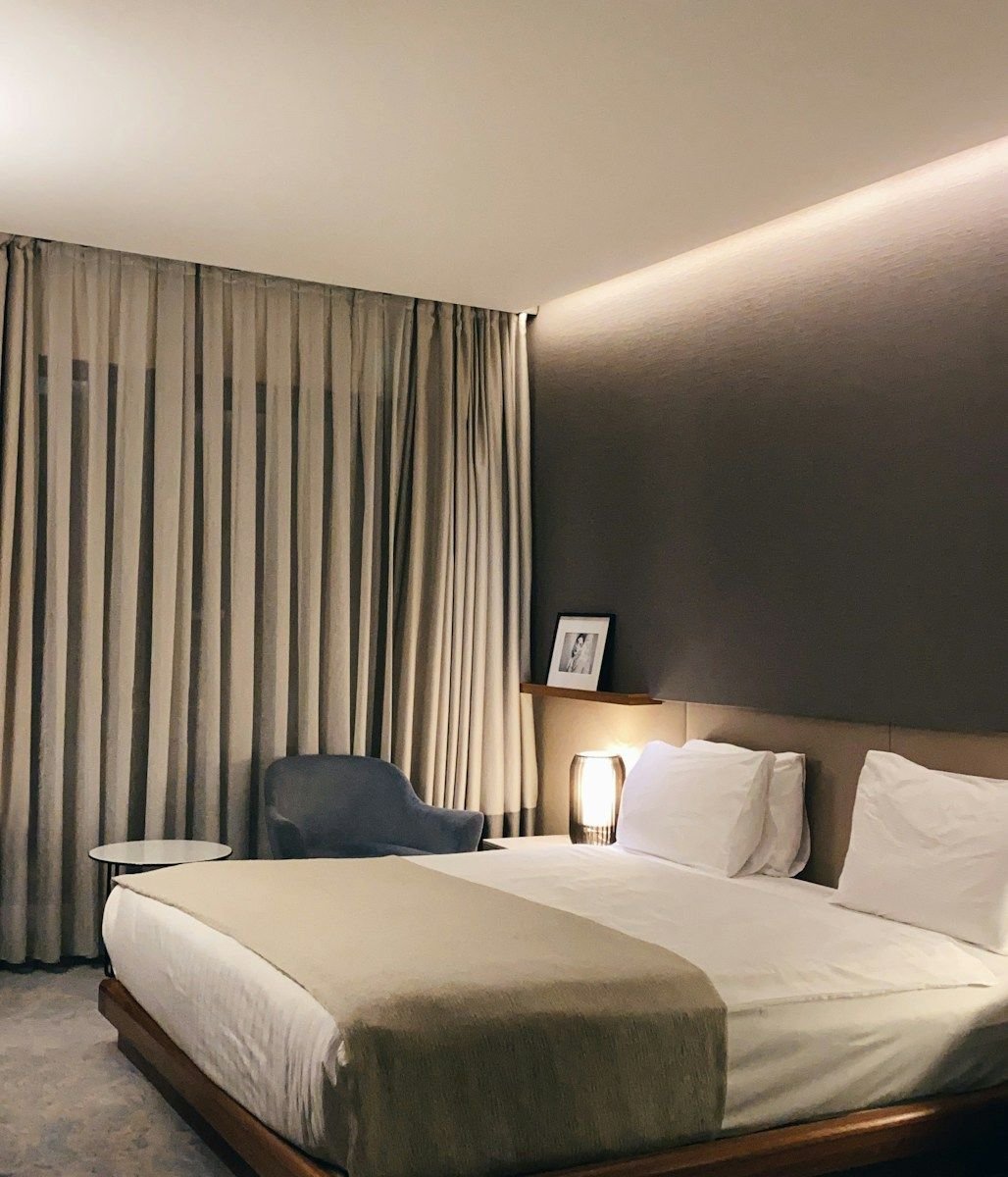 Clean minimalist bedroom with white bedding